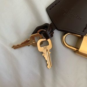 Louis Vuitton leash and bell and lock and keys.